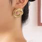 Three pairs of intertwined hoop stud earrings